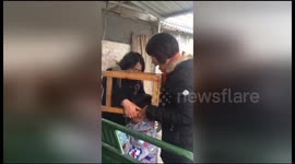 Naughty boy gets head stuck in chair