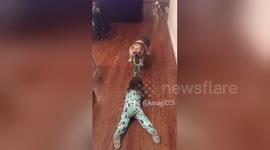 English Bulldog pulls toddler to 'clean the floor'