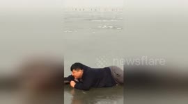 Man falls into frozen lake while ice skating