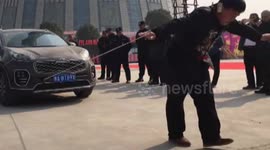 Kung-fu master pulls car with his ear