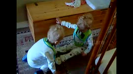Twins help each other with slippers!