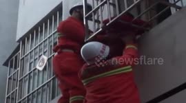 Toddler hangs from first floor window for half an hour before rescue