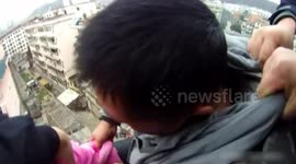 Man saves wife's life by grabbing her hair when she jumps out of the roof