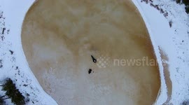 Magnificent aerial footage of 'crater pond' in Canadian wilderness