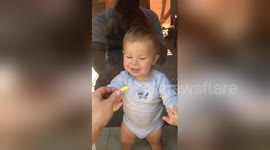 Newsflare Edit - Baby tries to eat Cheeto through glass door