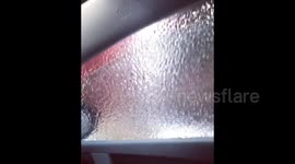Newsflare Edit - Woman rolls down window after freezing rain storm in Canada and gets a surprise