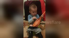 Newsflare Edit - My nephew is sitting on a baby potty and playing the dombra