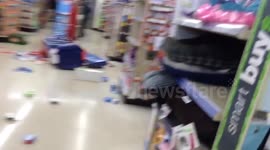 Man tears down items from Walgreens store.