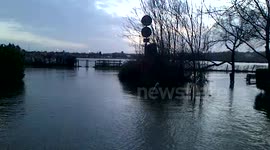 amphibious vehicle passes at top of flooded road