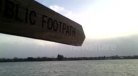 public  footpath sign pointing at the lake which is Runnymede