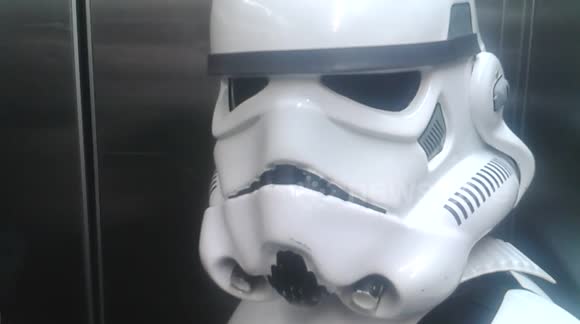 Man enters lift full of stormtroopers