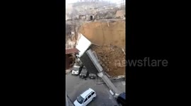 Police station courtyard wall collapse buries several vehicles