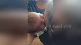 Four-day-old baby feeds off two-year-old sister's cheek