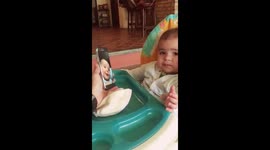 Two cute babies talk to each other by cell phone