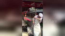 Enthusiastic man dances while he pulls one-strand noodle