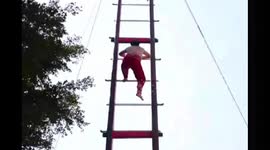 Man climbs sword ladder during village festivities