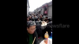 Villagers hold wedding banquet under snowfall