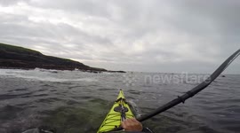 Powerful wave hits kayaker prompting emergency rescue