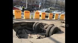 Semi-trailer wheels get stuck in sinkhole in China