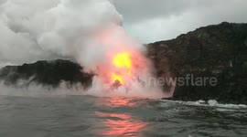Tourists enjoy impressive sights as lava meets the ocean in Hawaii