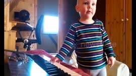 Little boy playing synthesizer for the first time