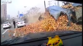 Lorry loaded with bricks flips over burying a car