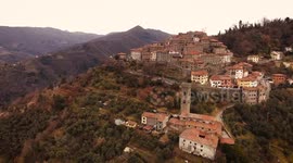 Aerial shot, gorgeous small perched town, in the middle of the nature, filmed with drone, 4K