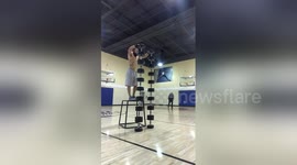 Man does handstand on dumbbell tower