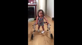 Toddler with Down's syndrome uses walker for the first time
