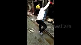 Market administrator cleans up street with hammer