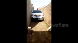 Car gets stuck in narrow alley