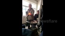 Kung fu master takes burning charcoal out of stove with barehand