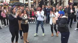 Bystanders join boy with Down's syndrome to dance in front of busker
