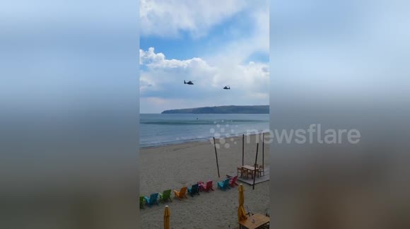 Military helicopters training over the sea
