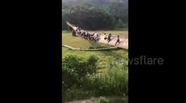 Over 20 visitors trapped on a chain bridge tilting to one side