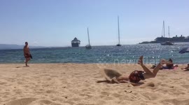 Fail at the beach? Somersaulting teen winds up faceplanting in the sand
