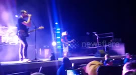 Blink 182 pulls random dude out if crowd to play and he kills it.