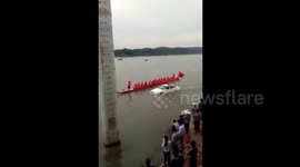 Car drives through river during dragon boat racing