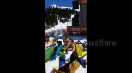 Shirtless man really enjoys a dance in the sunshine at ski resort