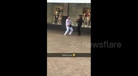 Man with walking stick dances along to street musician