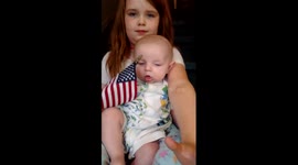 Cute baby waving his american flag.