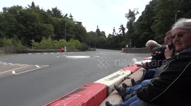 Rider skids across road into barrier during high-speed Isle of Man TT