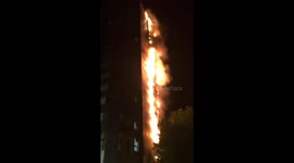 Debris falling from ablaze Grenfell Tower in West London