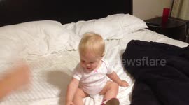 Baby playing cops and robbers.  Baby falls over