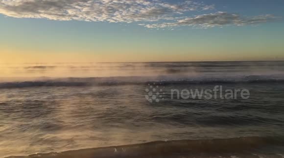 Steamy ocean beach sunise