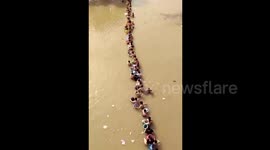 Hundreds of students queue to evacuate flooded dormitory