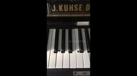 Piano with google eyes and lipstick on