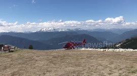 Helicopter taking off from the summit of BlackComb mountain