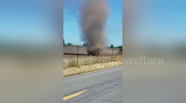Huge dust devil swirls across field