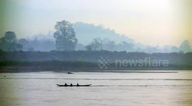 Mist rises on a timeless early morning on the Mekong River